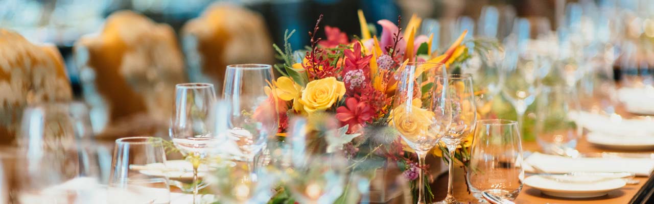 A table dressed for a wedding with flowers and glasses